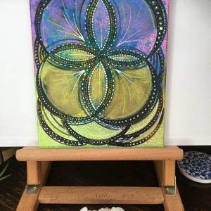 Black on blue, yellow and pink Mandala in acrylic pen on canvas - 12" x 8" by Carolyn Freeman